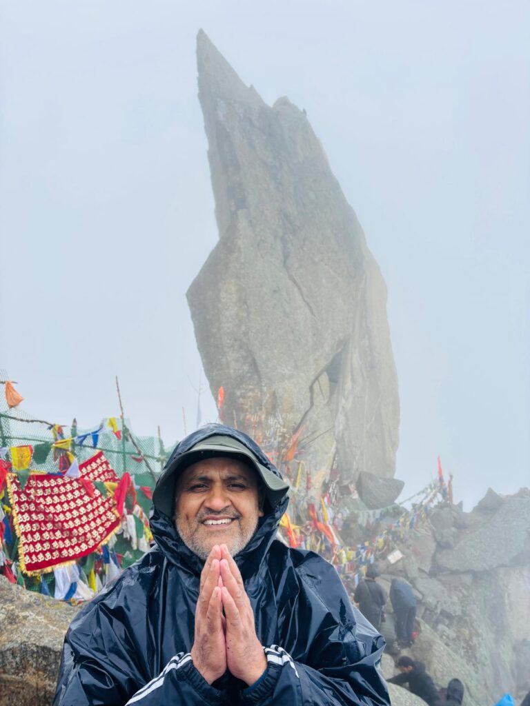 Trekker at Kinner Kailash Shivling peak offering prayers